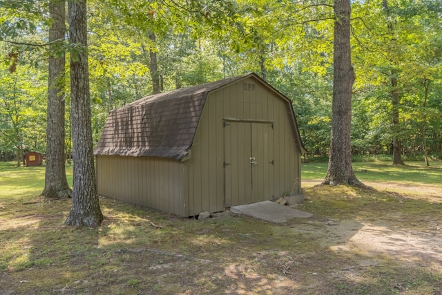 view of outdoor structure featuring a lawn