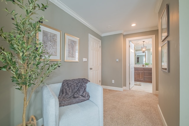 sitting room featuring light carpet, a chandelier, and crown molding