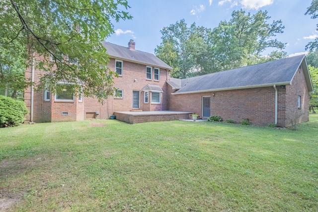 rear view of house featuring a lawn