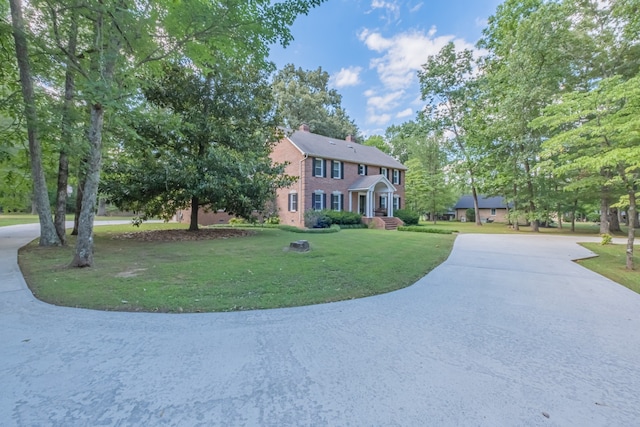 colonial home with a front lawn