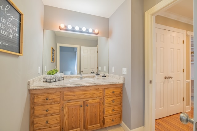 bathroom with toilet, vanity, and hardwood / wood-style flooring