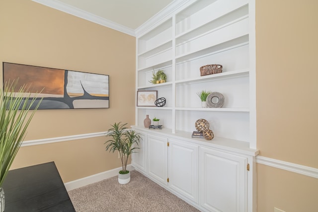 interior space featuring carpet flooring, built in shelves, and crown molding