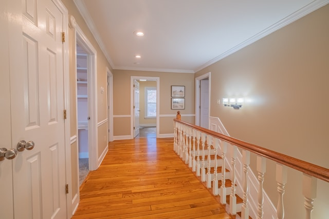 hall featuring crown molding and light hardwood / wood-style flooring