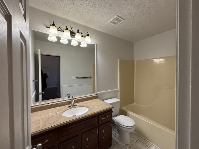 full bathroom with toilet, a textured ceiling, vanity, and tile patterned floors