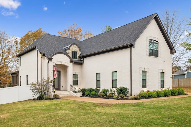 french country style house featuring a front yard