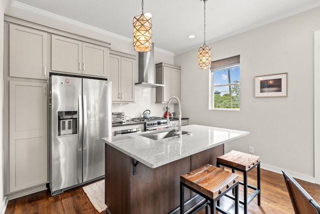 kitchen featuring light stone countertops, wall chimney exhaust hood, dark hardwood / wood-style floors, stainless steel fridge, and a breakfast bar area