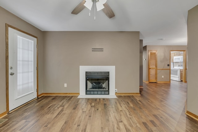 unfurnished living room featuring ceiling fan and hardwood / wood-style flooring