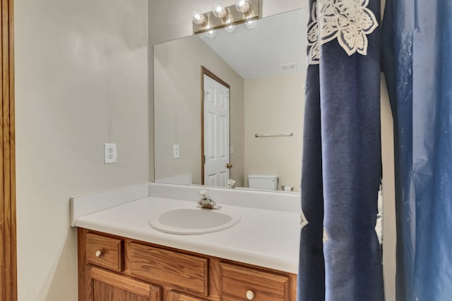 bathroom featuring vanity and toilet