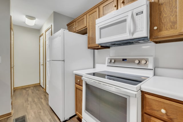 kitchen featuring white appliances and light wood-type flooring