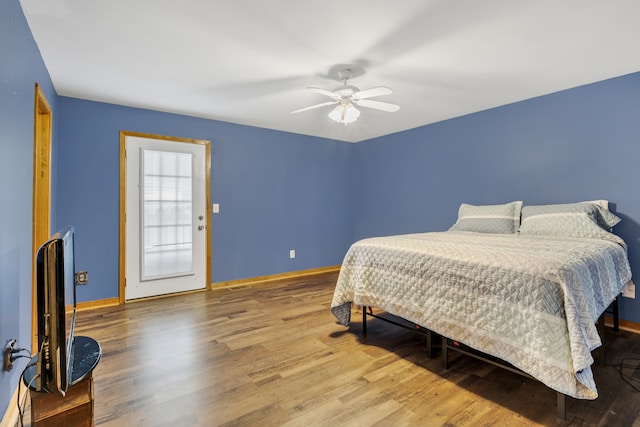 bedroom with ceiling fan and hardwood / wood-style flooring