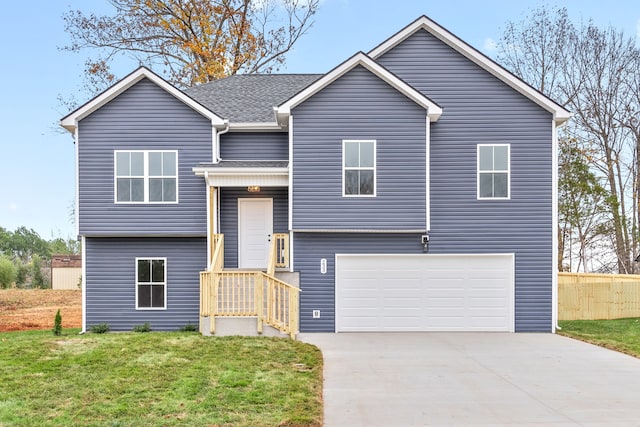 split foyer home with a shingled roof, concrete driveway, an attached garage, fence, and a front lawn