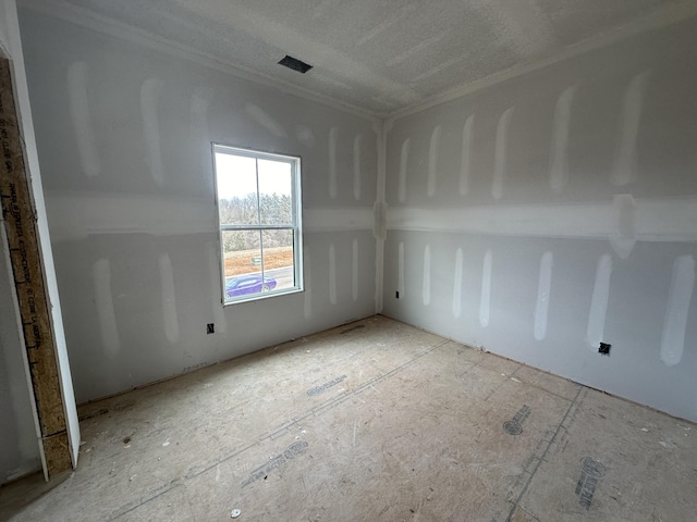 unfurnished room with a textured ceiling