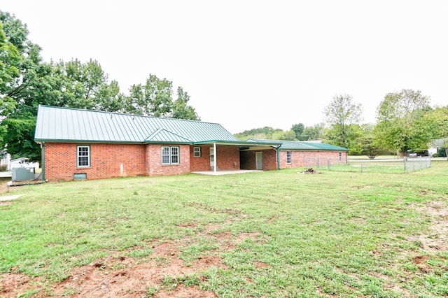 back of house featuring a yard