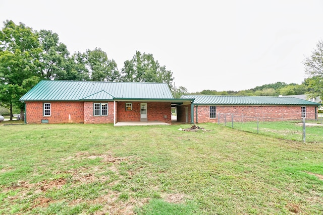 back of house featuring a yard and a patio