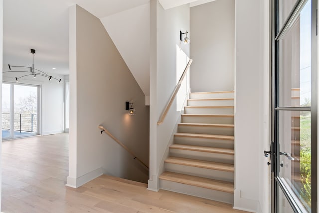 staircase with hardwood / wood-style floors