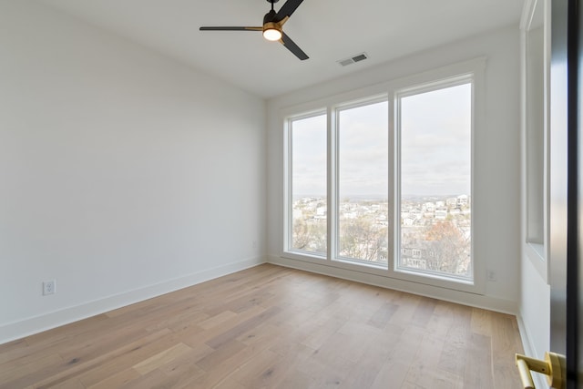 spare room featuring ceiling fan and light wood-type flooring