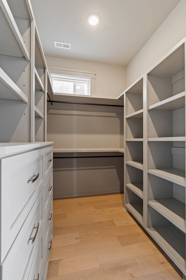 walk in closet featuring light hardwood / wood-style floors