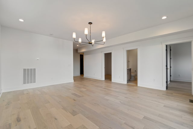 interior space with light hardwood / wood-style flooring and a notable chandelier