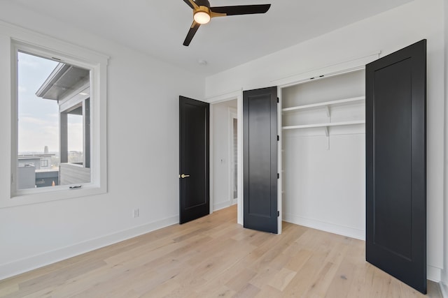 unfurnished bedroom featuring a closet, light hardwood / wood-style floors, and ceiling fan