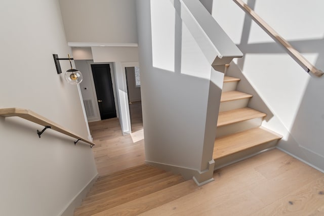 stairway featuring hardwood / wood-style flooring