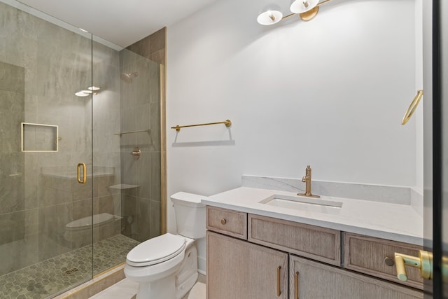 bathroom with vanity, toilet, and an enclosed shower