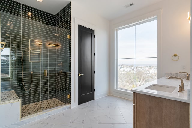 bathroom featuring vanity, an enclosed shower, and a wealth of natural light