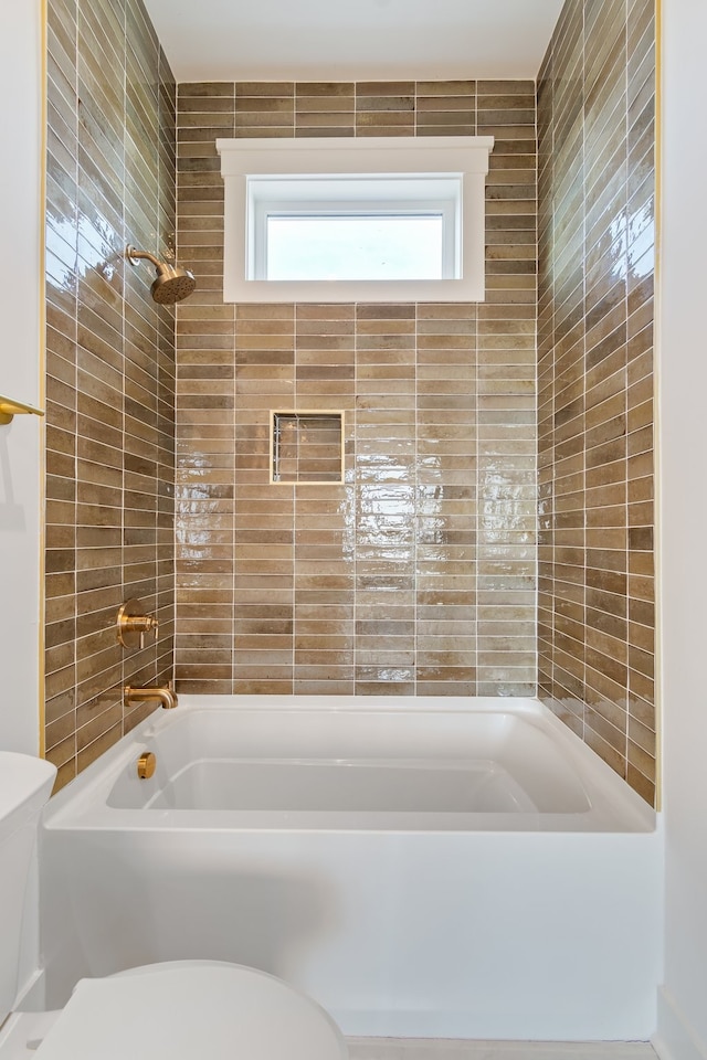 bathroom featuring shower / bathing tub combination and toilet