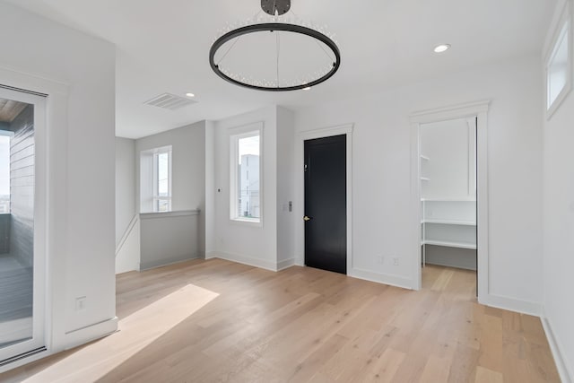 entrance foyer featuring a chandelier and light wood-type flooring