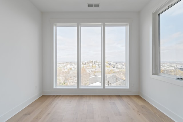 unfurnished room featuring light hardwood / wood-style flooring and plenty of natural light