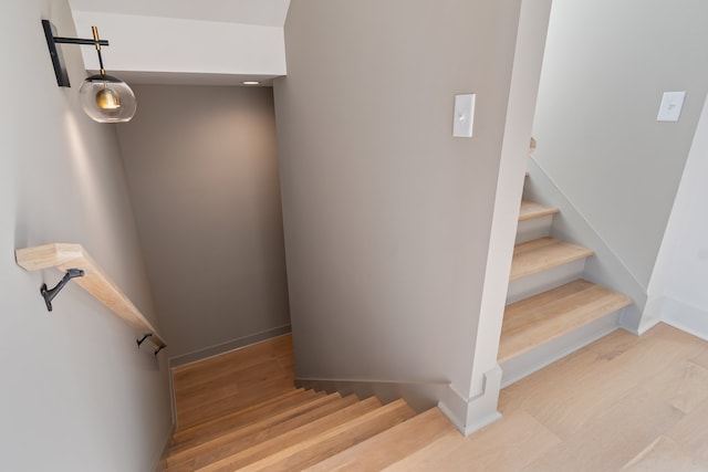 staircase with wood-type flooring