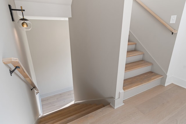 staircase with hardwood / wood-style flooring