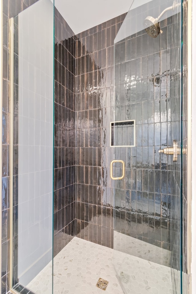 bathroom featuring a shower with door