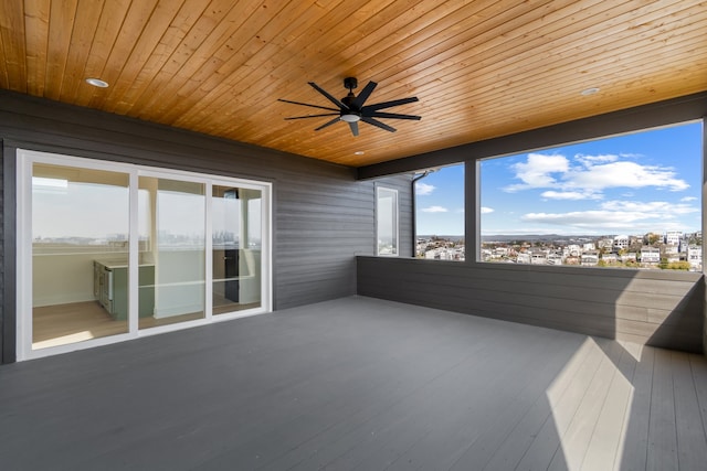 unfurnished sunroom with ceiling fan and wooden ceiling