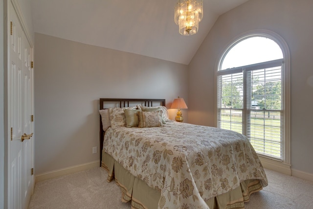 bedroom with an inviting chandelier, lofted ceiling, light carpet, and multiple windows