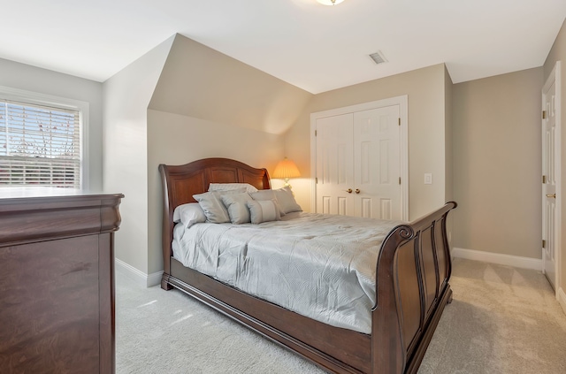 bedroom with light colored carpet and a closet