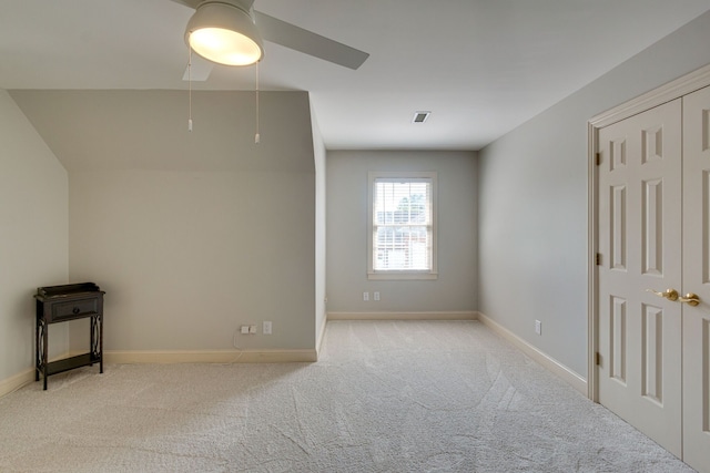 unfurnished room with ceiling fan and light colored carpet