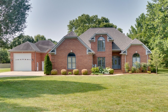 front of property with a front yard and a garage