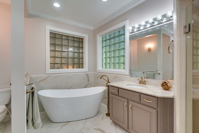 bathroom with vanity, a bathing tub, crown molding, toilet, and tile walls