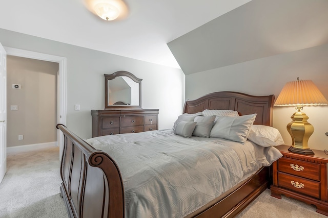 carpeted bedroom with vaulted ceiling