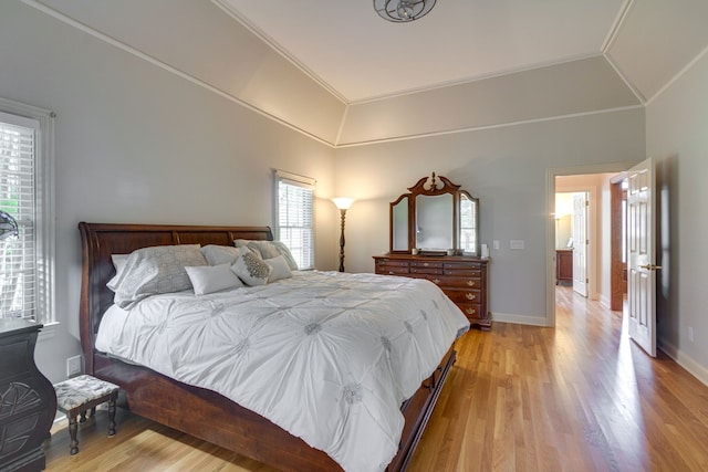 bedroom with multiple windows, crown molding, light hardwood / wood-style flooring, and lofted ceiling