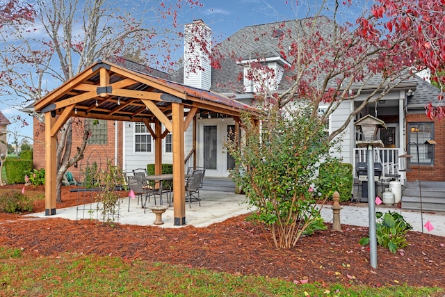 view of front of house featuring a gazebo and a patio