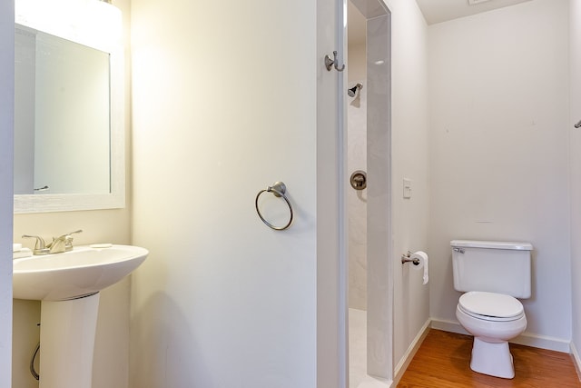 bathroom with sink, hardwood / wood-style floors, and toilet