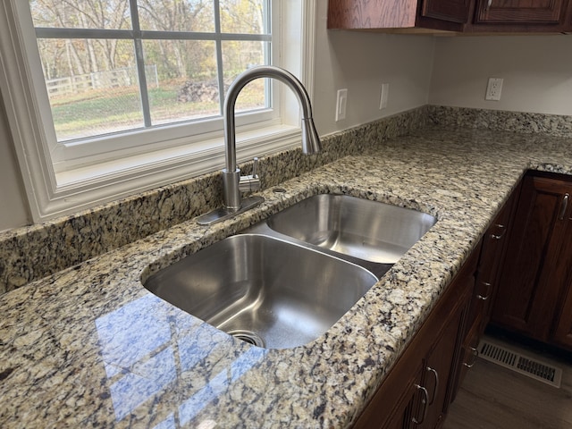 interior details with light stone countertops and sink