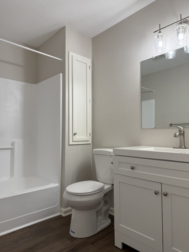 full bathroom with vanity, toilet, a textured ceiling, shower / bathtub combination, and wood-type flooring