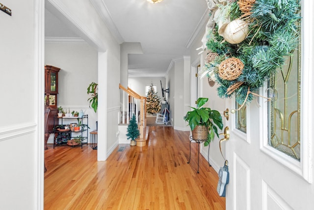 foyer featuring crown molding and light wood-type flooring