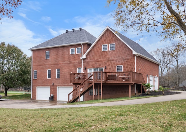 back of house featuring a garage, a yard, and a wooden deck