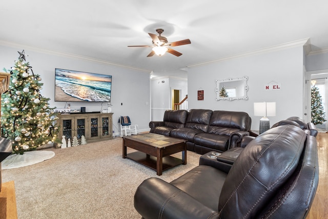 living room featuring carpet, ceiling fan, and crown molding