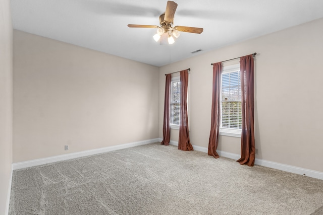 unfurnished room with ceiling fan and light carpet