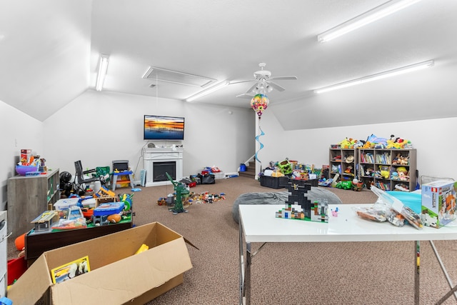 recreation room with carpet flooring, vaulted ceiling, and ceiling fan