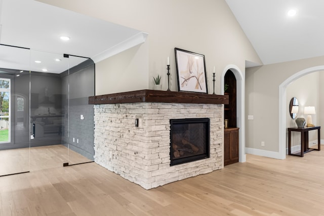 unfurnished living room with light hardwood / wood-style floors, a fireplace, and vaulted ceiling